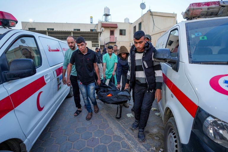 Palestinians carry the body of a World Central Kitchen worker at Al Aqsa hospital in Deir al-Balah, Gaza Strip