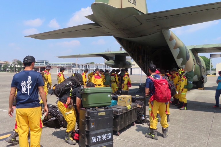 A search and rescue team loading an air force plane to go to Hualien