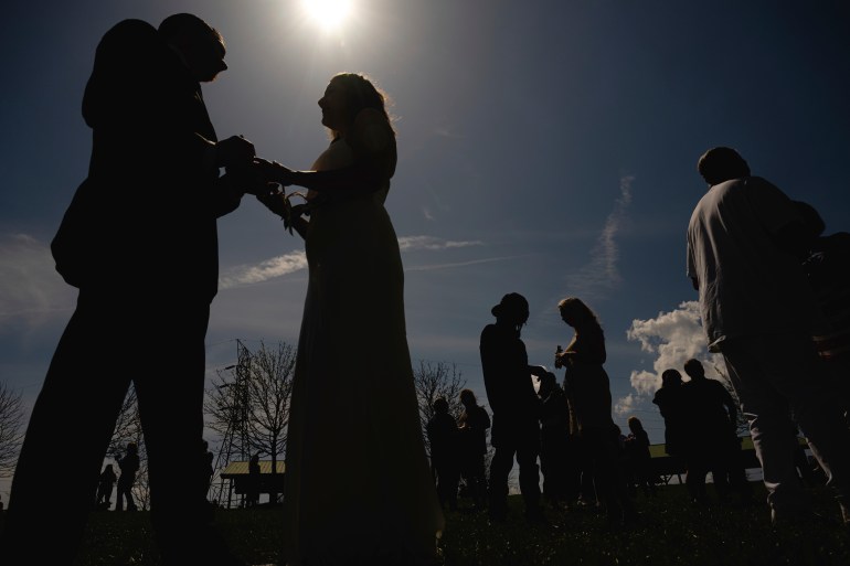 Couples to be wed exchange wings just before totality during a solar eclipse