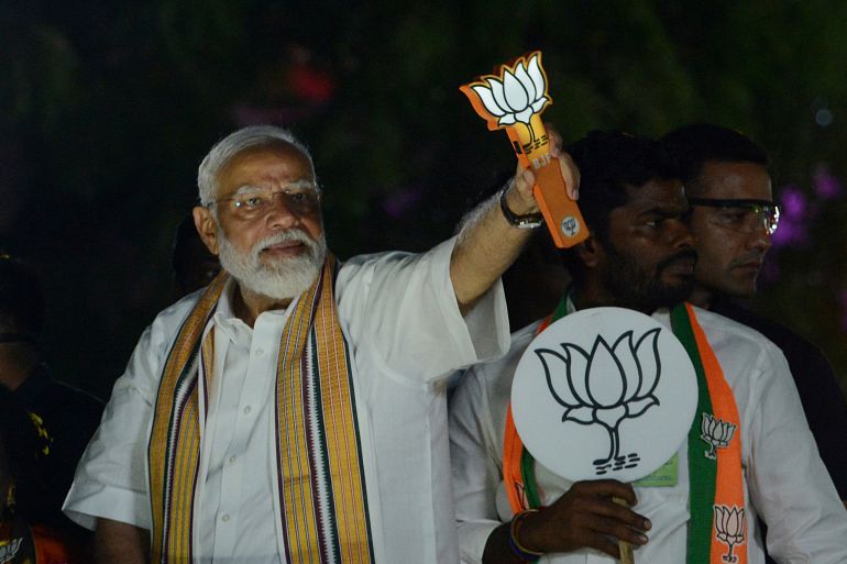 Indian Prime Minister Narendra Modi displays the Bharatiya Janata Party (BJP) symbol, lotus, during a road show while campaigning for national elections, in Chennai, India, Tuesday, April 9, 2024. (AP Photo)