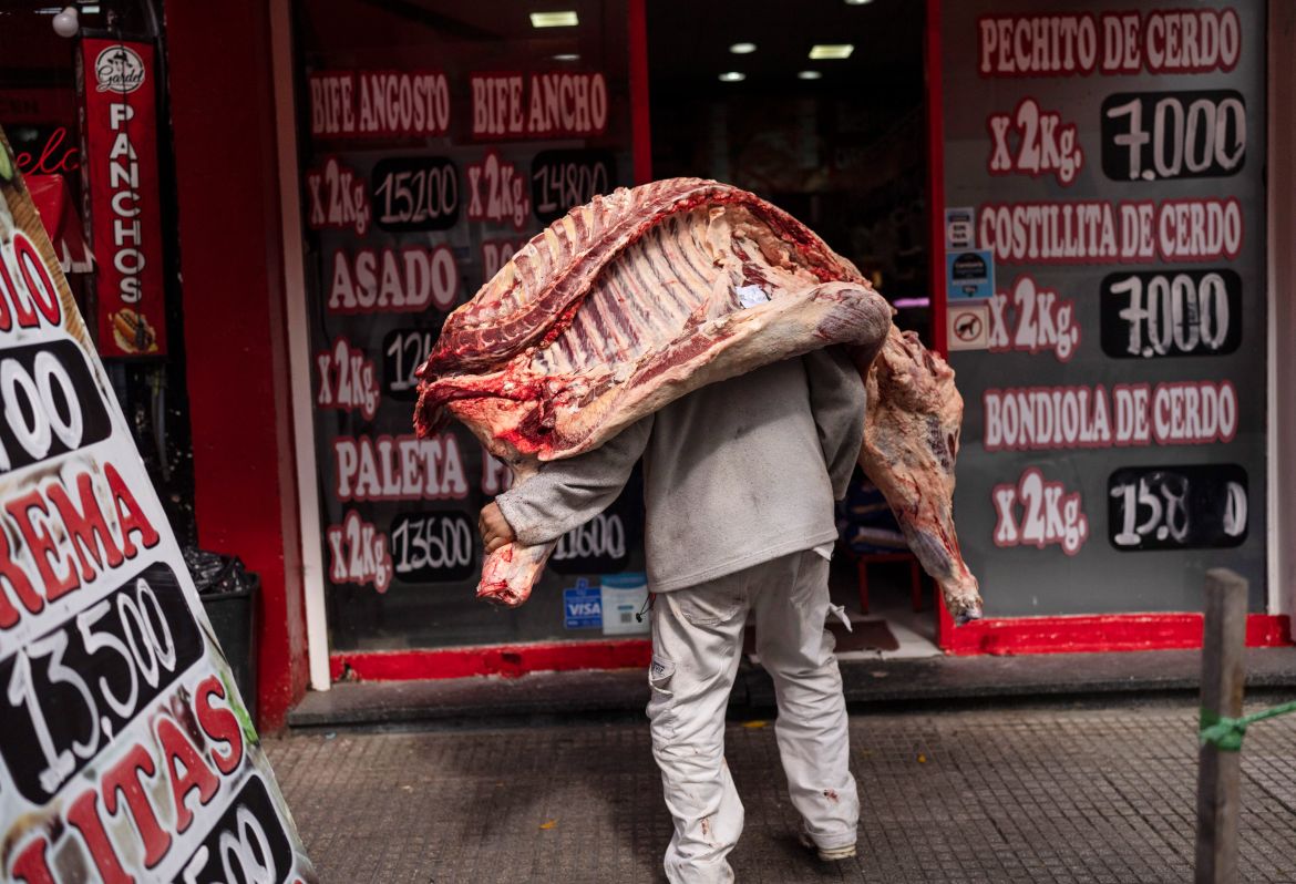 A seller delivers a beef carcass to a butcher shop in Buenos Aires, Argentina, April 10