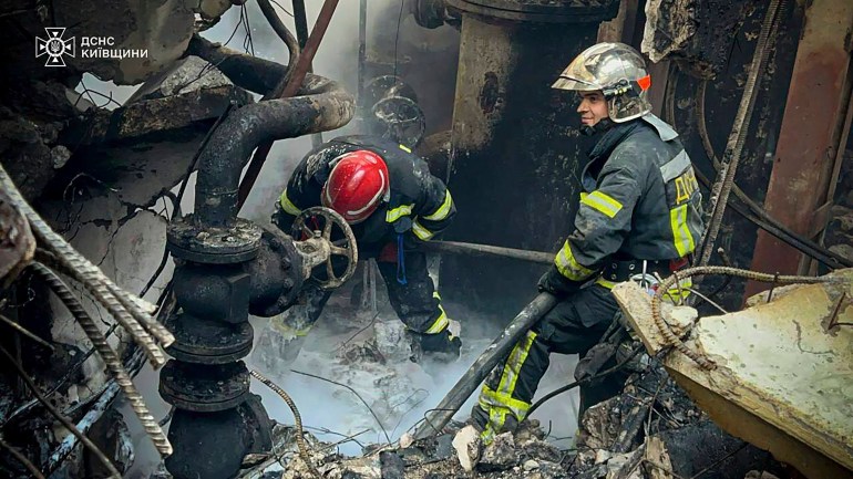 In this photo provided by the Ukrainian Emergency Service, emergency workers extinguish a fire after a Russian attack on the Trypilska thermal power plant in Ukrainka, Kyiv region, Ukraine
