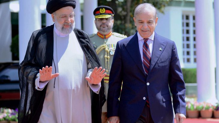 In this photo released by Prime Minister Office, Iranian President Ebrahim Raisi, left, walks with Pakistan's Prime Minister Shehbaz Sharif during a welcome ceremony in the prime minister house in Islamabad, Pakistan.