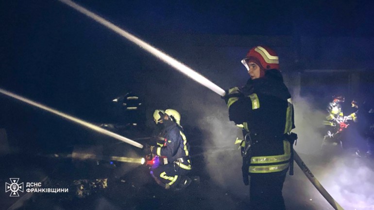 Emergency services personnel work to extinguish a fire 