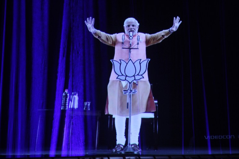 India's main opposition Bharatiya Janata Party (BJP)'s prime ministerial candidate Narendra Modi addresses the public via a 3D projection as part of his election campaign in Ahmadabad, India, Friday, April 11, 2014. The 63-year-old Modi is leading his Bharatiya Janata Party's bid to wrest power from the Congress party in the national elections that are being decided in multiphase voting through May 12. Results will be announced on May 16. (AP Photo/Ajit Solanki)