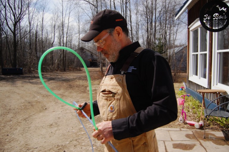 Quebec maple syrup producer Jean-Francois Touchette holds a piece of tubing used to tap maple trees