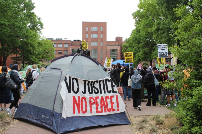 Tent with a banner that says, "No justice, no peace"