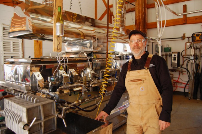 Quebec maple syrup producer Jean-Francois Touchette stands next to an evaporator, a machine used in maple syrup production