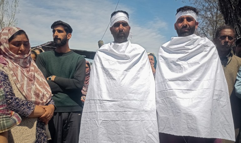 Residents of Reshipora Shopian staged a protest, wearing shrouds to reiterate their demand for project relocations of their land for the proposed railway line on April 2, 2024.