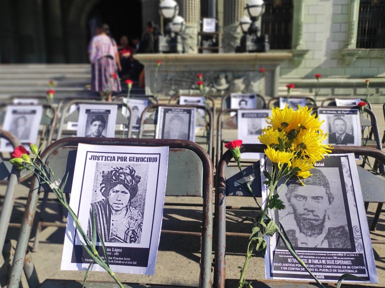 Black-and-white photos are propped up outside of a courthouse in Guatemala City, Guatemala