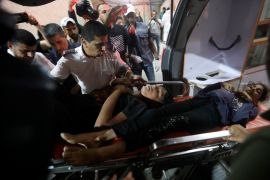 Palestinians wounded in Israeli bombardment are brought to the Kuwaiti Hospital in Rafah on Friday [Ismael Abu Dayyah/AP]