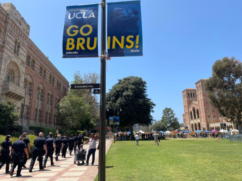 Police march towards a pro-Palestine encampment at UCLA