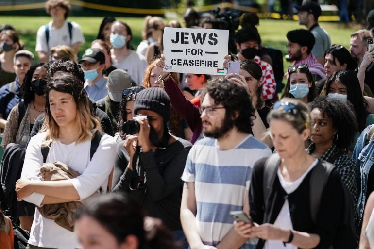A protester holds up a 'Jews for Ceasefire' sign during a pro-Palestinian protest against the war in Gaza at Emory University on April 25