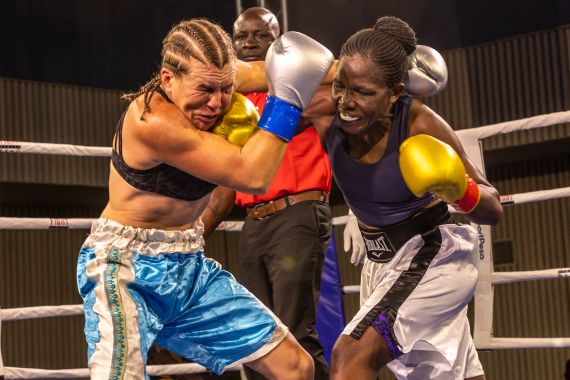 Sweden's Sandra Attermo (L) fights against Kenya's Consolata Musangi during their Women Super Bantamweight boxing title bout at the Edge Convention Centre, in Nairobi