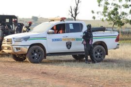 Police officers stand guard outside the school where children were kidnapped by gunmen in Kebbi, Nigeria [File: Deeni Jibo/AP Photo]