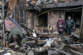 People survey the destruction after a Russian attack on a nine-storey residential building in the city of Vyshhorod in the Kyiv region, Ukraine, on Sunday [Maxym Marusenko/EPA]