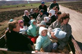 Ethnic Albanian refugees from Kosovo&#039;s village of Prekaz sit in a trailer near the village on March 6, 1998 [Reuters]