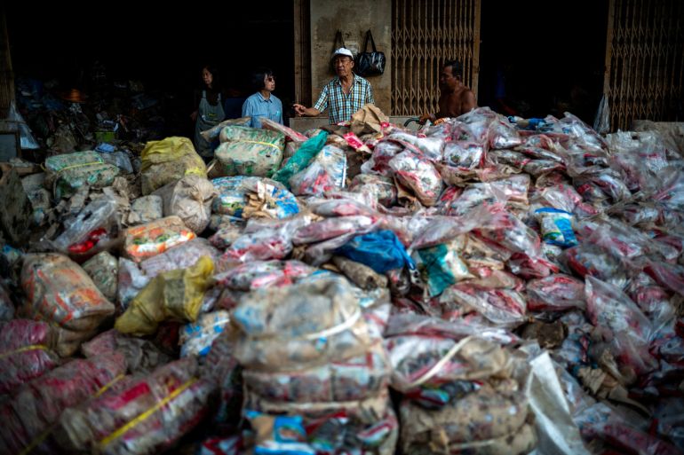 Shop owners stand next to their flood-damaged products following deadly flooding in Hat Yai district, Songkhla province, Thailand, November 30, 2025.