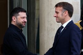 French President Emmanuel Macron welcomes Ukrainian President Volodymyr Zelenskyy as he arrives for a meeting at the Elysee Palace in Paris, France, December 1, 2025 [Gonzalo Fuentes/ Reuters]