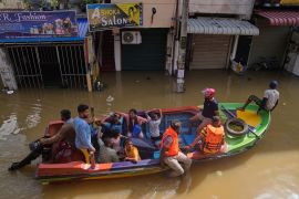 Rescuers move people to safety in a flooded area of Colombo, Sri Lanka [Eranga Jayawardena/AP Photo]