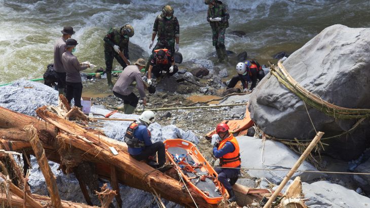 Rescuers search for flood victims in Tanah Datar, West Sumatra, Indonesia, Monday, Dec. 1, 2025.