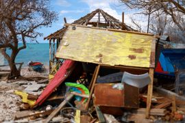 A fisherman fixes his boat, damaged by Hurricane Melissa, on Treasure Beach, in Saint Elizabeth, Jamaica, November 5, 2025 [File: Raquel Cunha/Reuters]