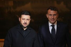 French President Emmanuel Macron, right, and Ukrainian President Volodymyr Zelenskyy arrive to give a joint news conference at Elysee Palace in Paris, France, December 1, 2025 [Christophe Ena/ Reuters]