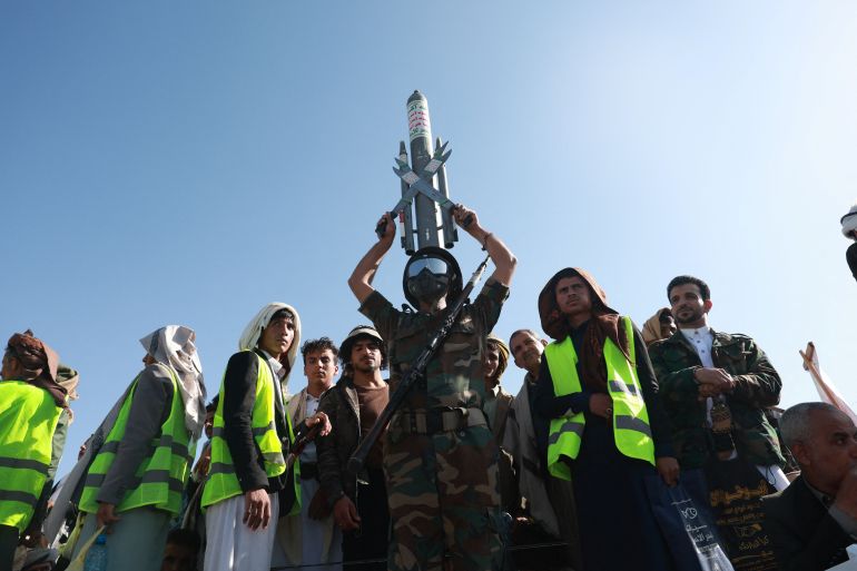 A Houthi supporter wearing a military uniform holds a mock missile as he joins Houthi supporters in a rally to show support to the movement as fighting intensifies across several Yemeni fronts, in Sanaa, Yemen October 9, 2026.