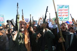Supporters of the Houthi authorities brandish their weapons during a protest against Saudi intervention in Yemen, in Sanaa, on October 9, 2026.