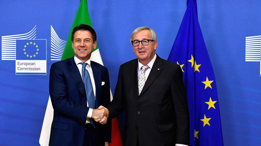 Under Giuseppe Conte, left, Italy's relationship with the EU has become increasingly strained [File: Piroschka van de Wouw/Reuters]