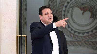 Ayman Odeh, leader of Hadash-Ta'al party, points as he stands near a door at Israel's Supreme Court in Jerusalem March 13, 2019. Picture taken March 13, 2019. REUTERS/Ammar Awad