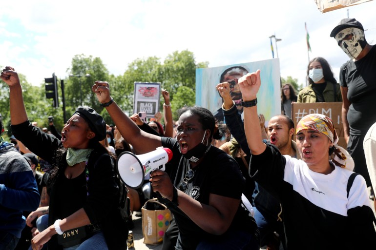 Demonstrators raise their fists during a Black Lives Matter protest following the death of George Floyd in Minneapolis police custody, in London, Britain, June 13, 2020. REUTERS/Simon Dawson