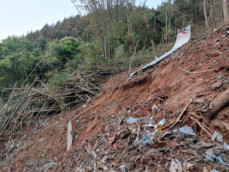 Metal debris in the white colours of China Eastern strewn on the hillside in southern China 