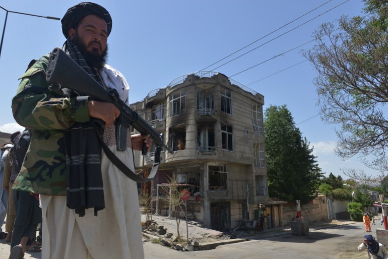 A Taliban fighter stands guard in front of the Sikh temple in Kabul following an attack by gunmen on June 18, 2022 [Sahel Arman/AFP]