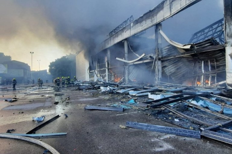 Rescuers work at a site of a shopping mall hit by a Russian missile in Kremenchuk, Ukraine.