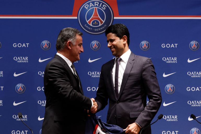 Christophe Galtier is presented with the club jersey by Paris St Germain president Nasser Al-Khelaifi, during the press conference