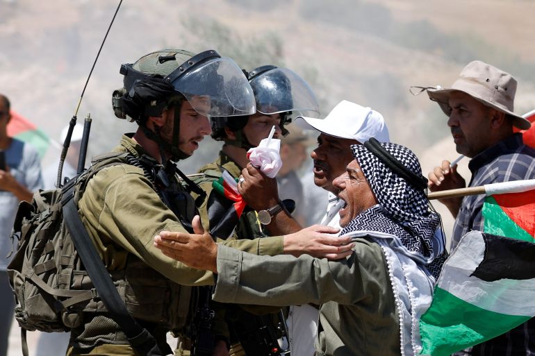 A Palestinian confronts an Israeli soldier