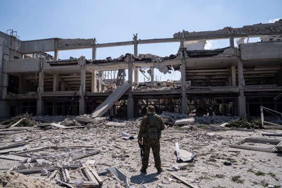 A Ukrainian service member looks on the National Pedagogic University destroyed by a Russian attack in Kharkiv, Ukraine.
