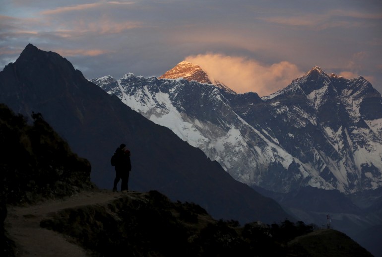 Light illuminates Mount Everest (C) during sunset in Solukhumbu district, also known as the Everest region, in this picture taken November 30, 2015.