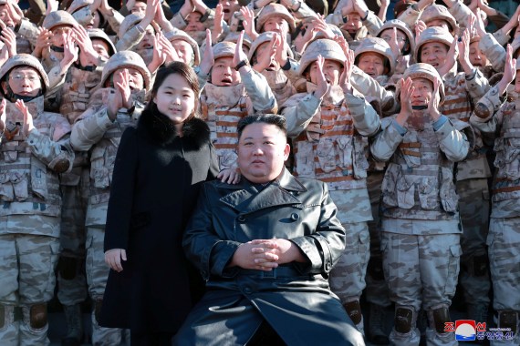 North Korean leader Kim Jong Un and his daughter attend a photo session with the scientists, engineers, military officials and others involved in the test-fire of the country's new Hwasong-17 intercontinental ballistic missile.