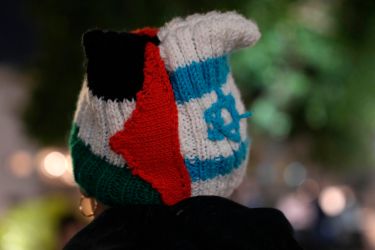 A person wears a knit cap in the colors of the Palestinian and Israeli flags in Tel Aviv, Israel, during a protest against Prime Minister Benjamin Netanyahu's far-right government, Saturday, Jan. 7, 2023.