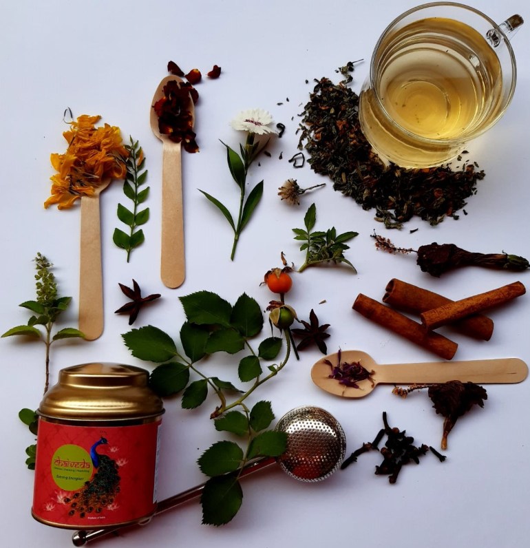 Photo of a cup of tea with spices and herbs arrayed around it