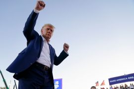 Former President Donald Trump dances with his arms raised during a campaign rally after speaking at Waco Regional Airport.