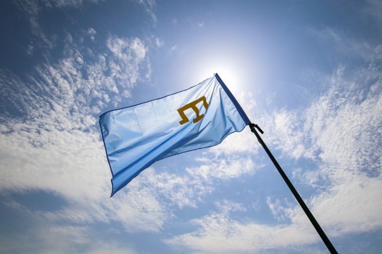 A Crimean Tatars flag flies at a rally, commemorating Crimean Tatars mass deportations from the region in 1944, in the village of Siren, in Bakhchisaray district, Crimea, May 18, 2019. REUTERS/Alexey Pavlishak