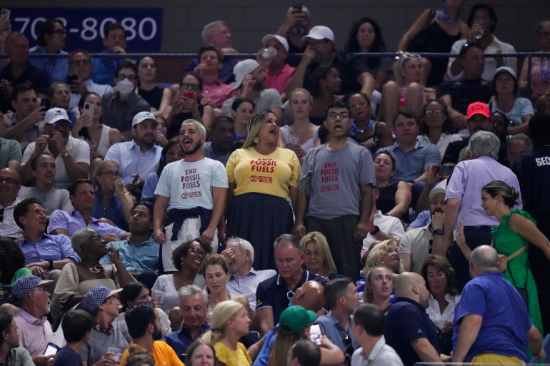 Protesters demonstrate at a match between Coco Gauff, of the United States, and Karolina Muchova, of the Czech Republic, during the women's singles semifinals of the U.S. Open tennis championships