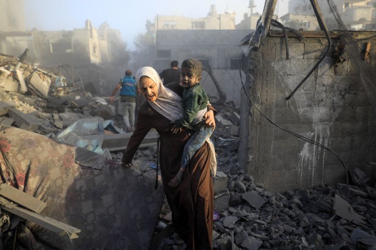 People flee following Israeli air strikes on a neighbourhood in the al-Maghazi refugee cam