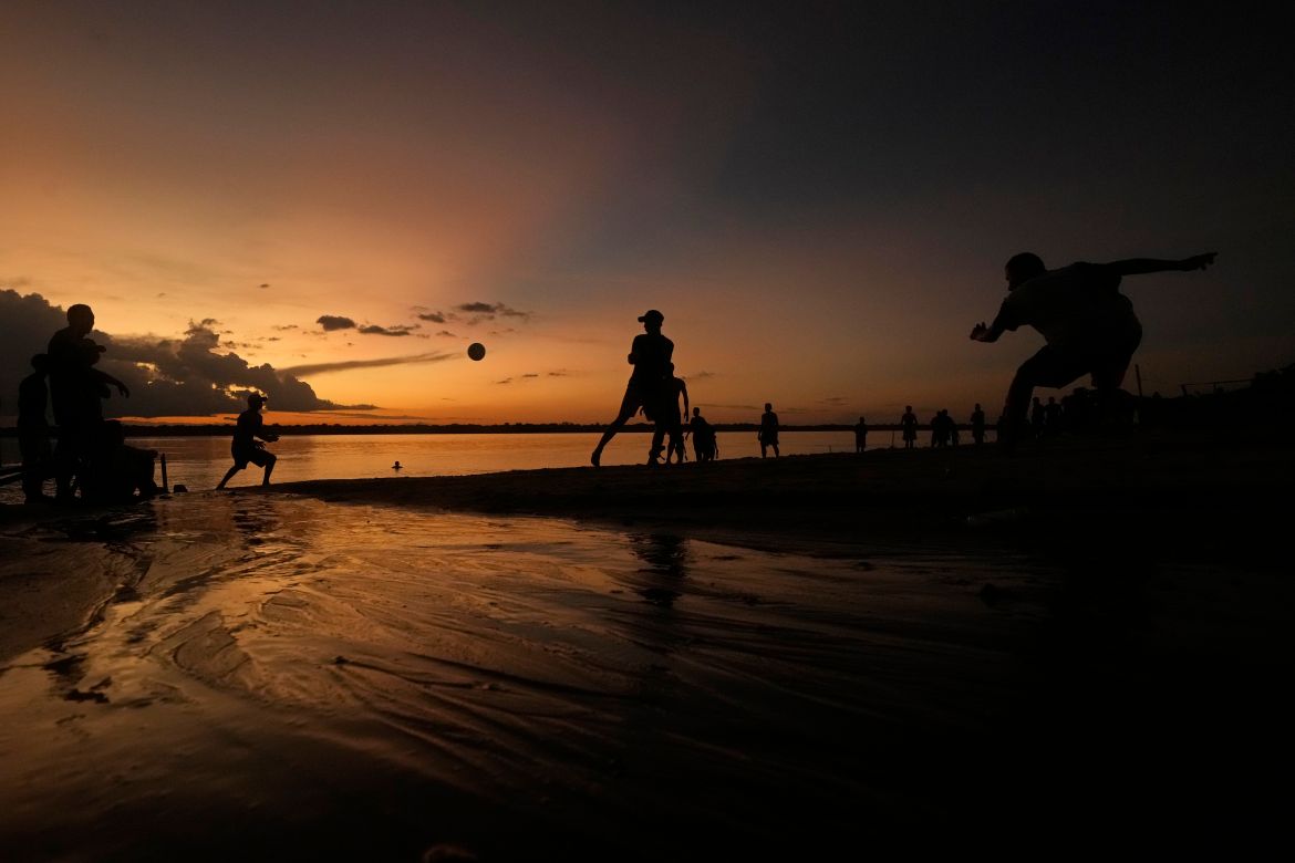 Residents play ball at sunset on the sands of the Tocantis River, in the city of Mocajuba, Para state, Brazil.