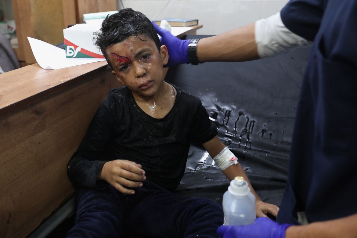Palestinian boy wounded in an Israeli strike is assisted, after a temporary truce between Hamas and Israel expired, at Nasser hospital in Khan Younis