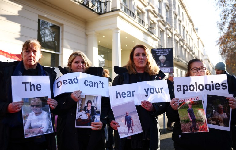 Protesters holds a placard reading "The dead can't hear your apologies" during a gathering outside the UK Covid-19 Inquiry building in west London, on December 6, 2023 [HENRY NICHOLLS / AFP]
