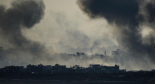 This picture taken from southern Israel near the border with the Gaza Strip shows smoke rising from buildings after being hit by Israeli strikes, after battles resumed between Israel and Hamas militants.